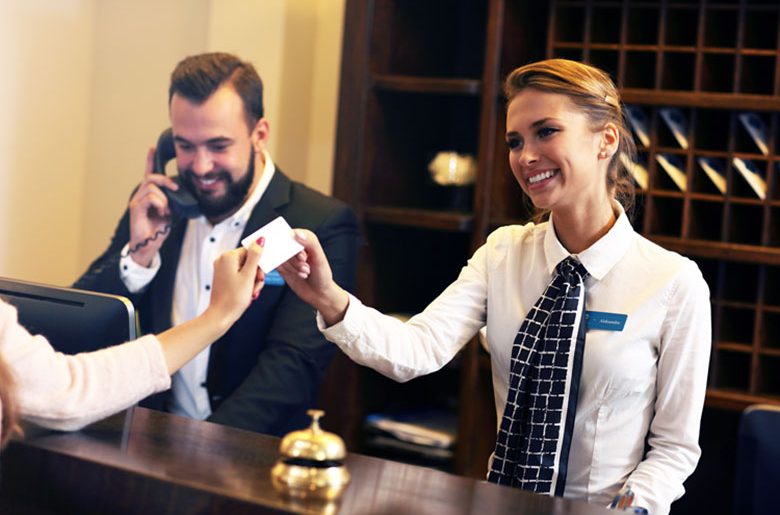 Front desk office handing over a business card