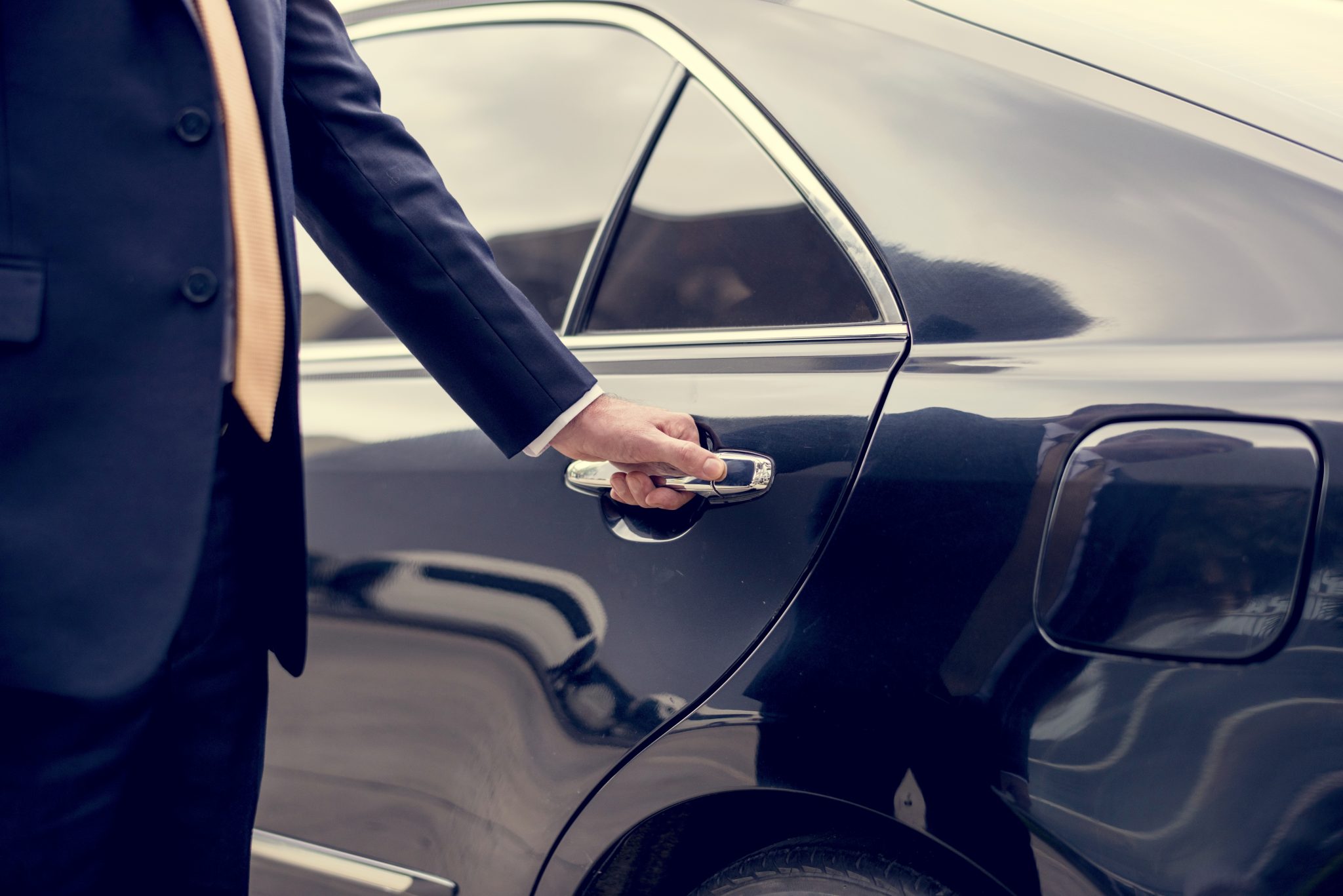 Man holding the handle of the car